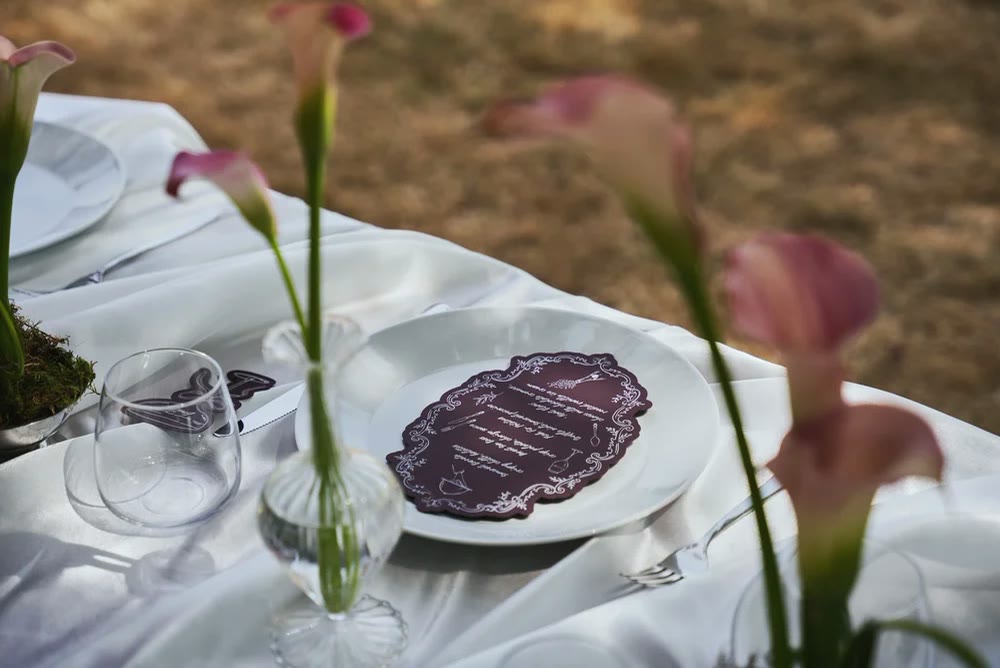A table laid with calla lilies and a Maroux menu